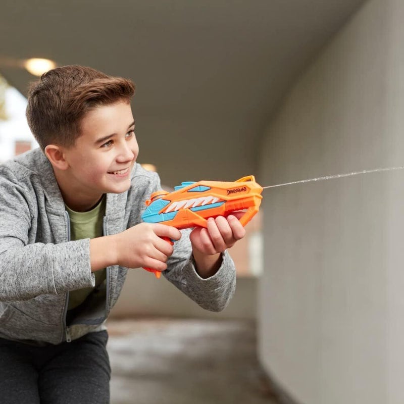 Kid playing with Dinosquad Raptor Surge nerf gun